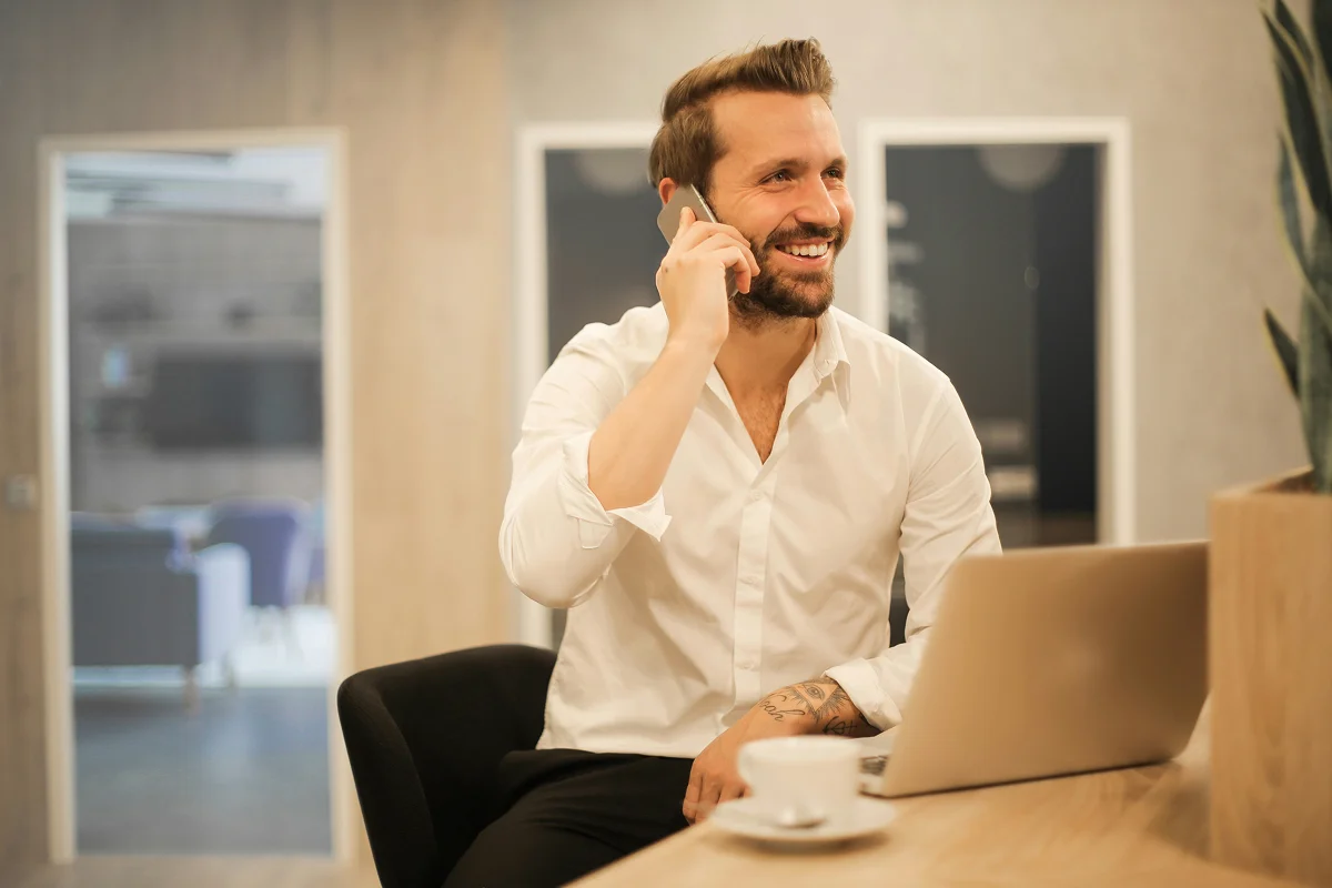 Confident B2B executive on a call with laptop — pipeline always running